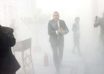 Far-right Polish MP puts out menorah with fire extinguisher in parliament